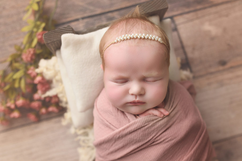 Baby Girl wrapped in pink with flowers and pearls