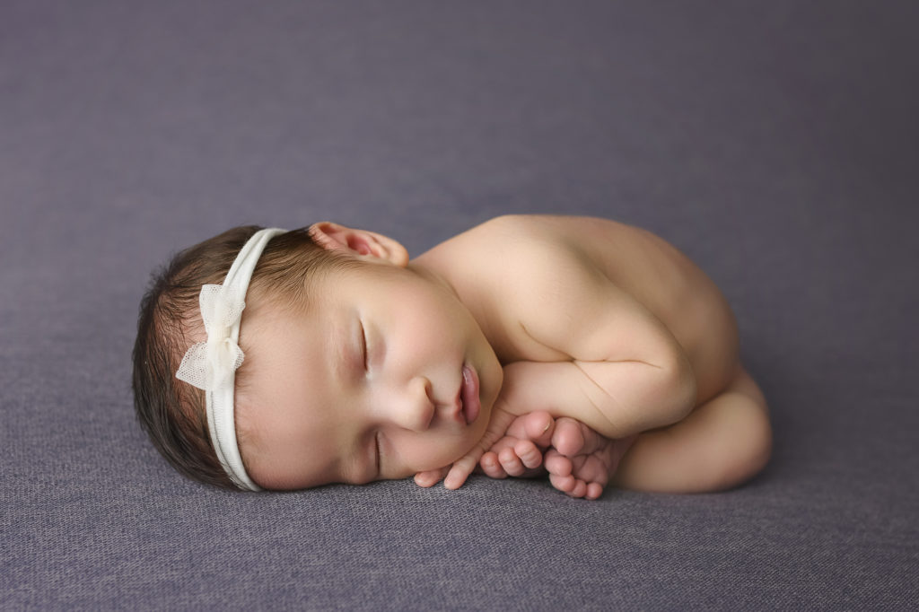Newborn girl with white bow