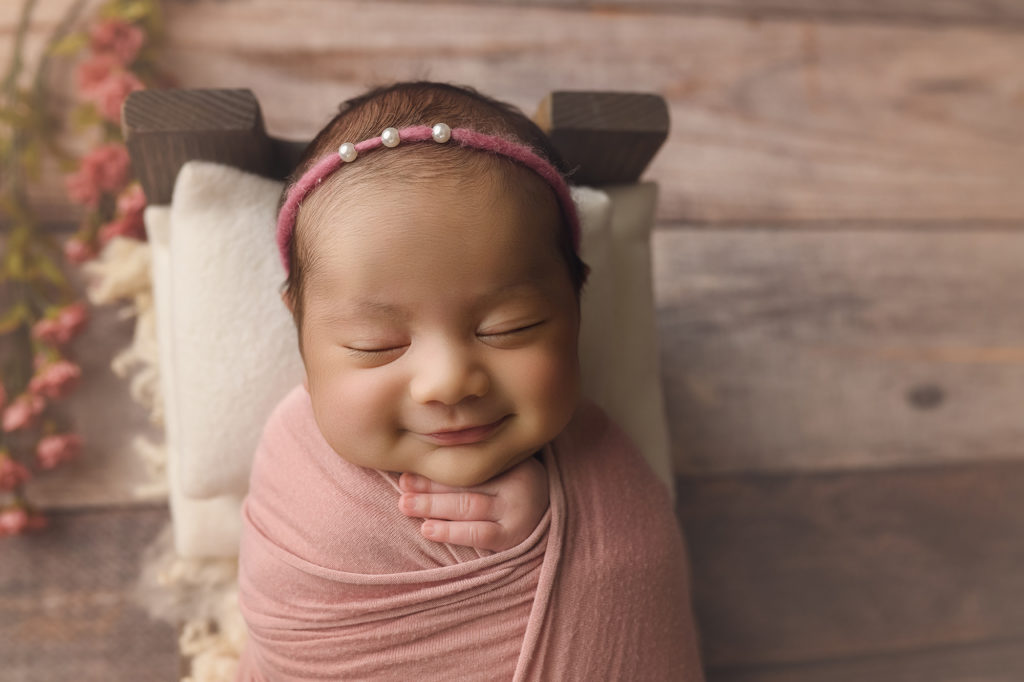 Smiling newborn baby girl