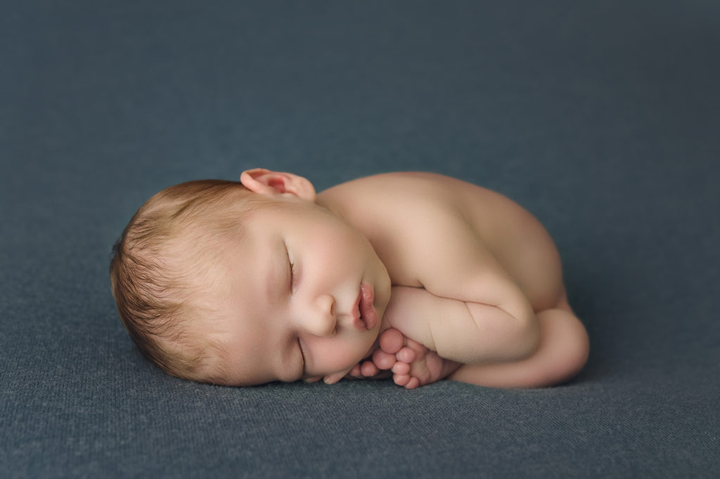 Raleigh Newborn Photographer Newborn baby boy laying on blue blanket
