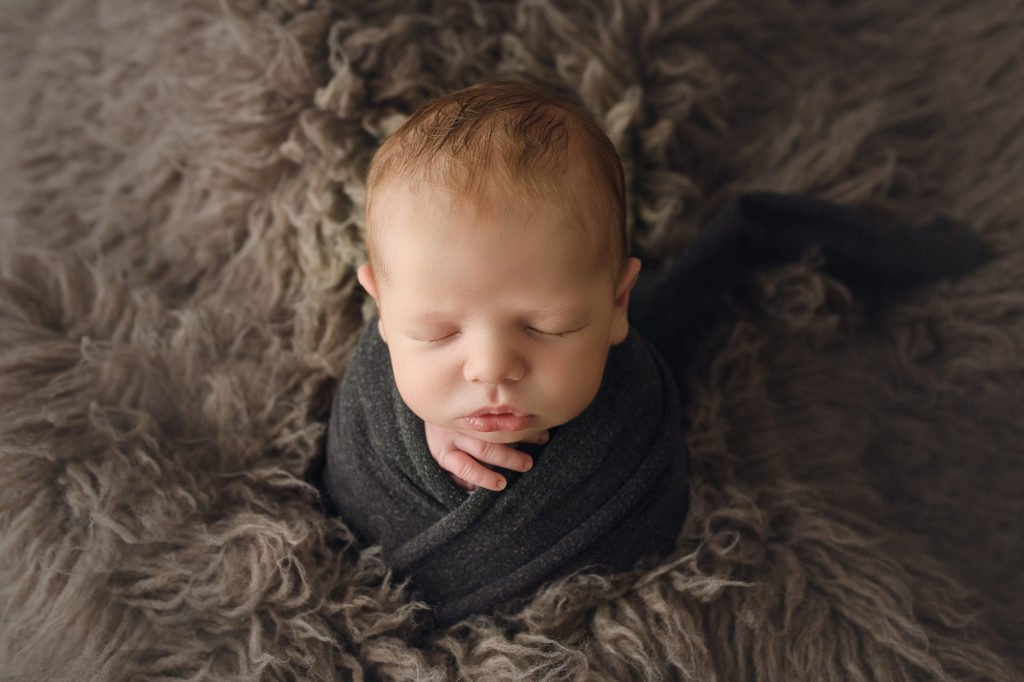Raleigh Newborn Photographer Newborn baby boy on gray fur