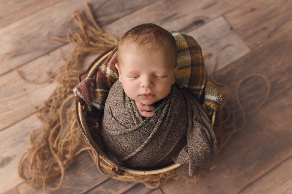 Raleigh Newborn Photographer Newborn baby boy in bucket with a wrap