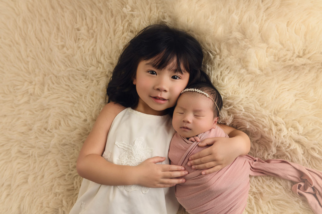 newborn baby girl with big sister
