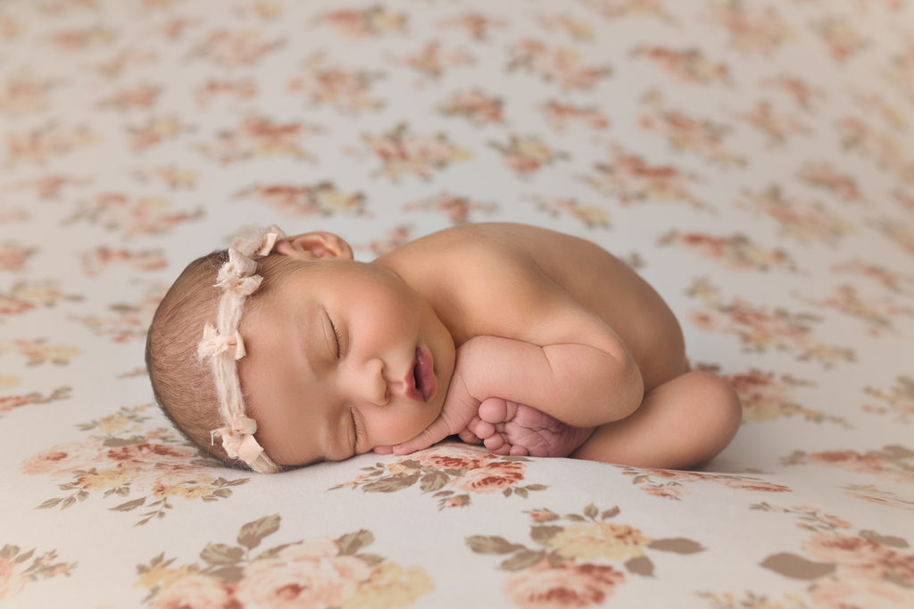 Newborn baby girl Ella on floral blanket
