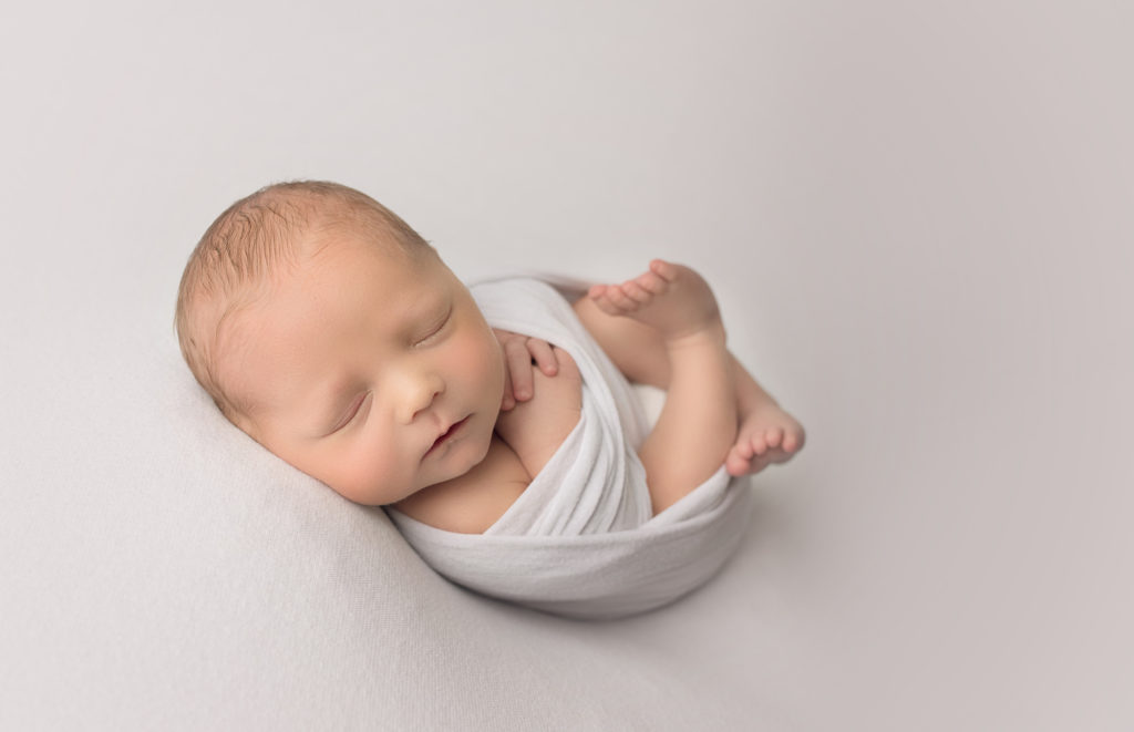 newborn baby boy in white