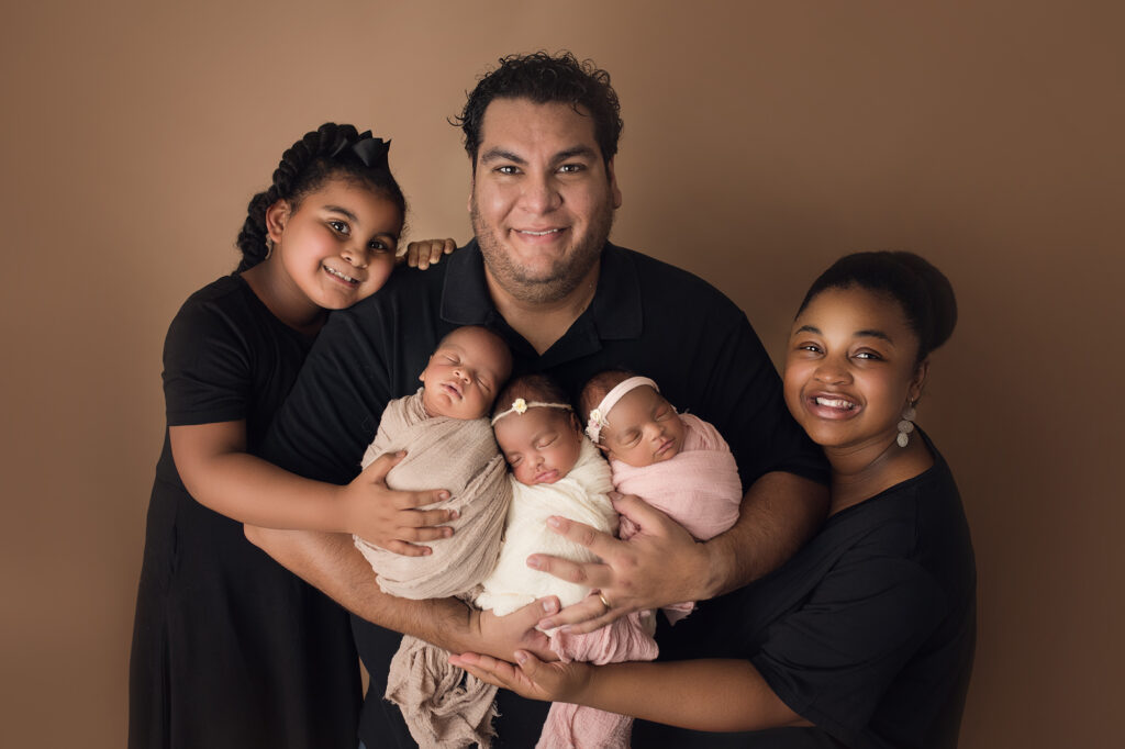Newborn Triplets Family with mom, dad and big sister