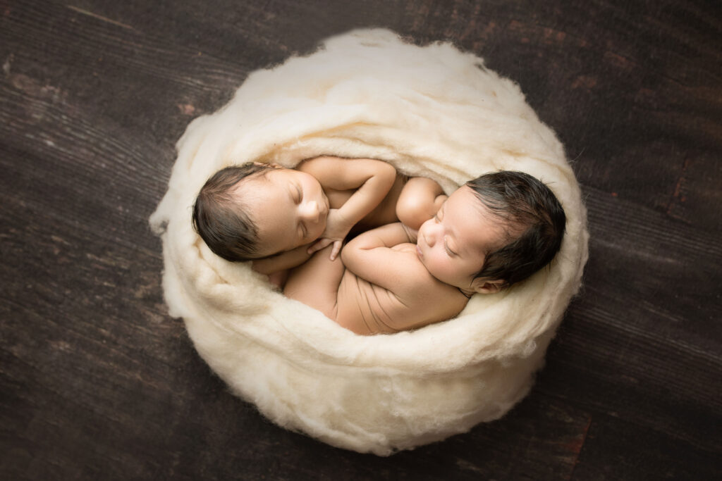 Newborn Twin Boys curled into yin and yang
