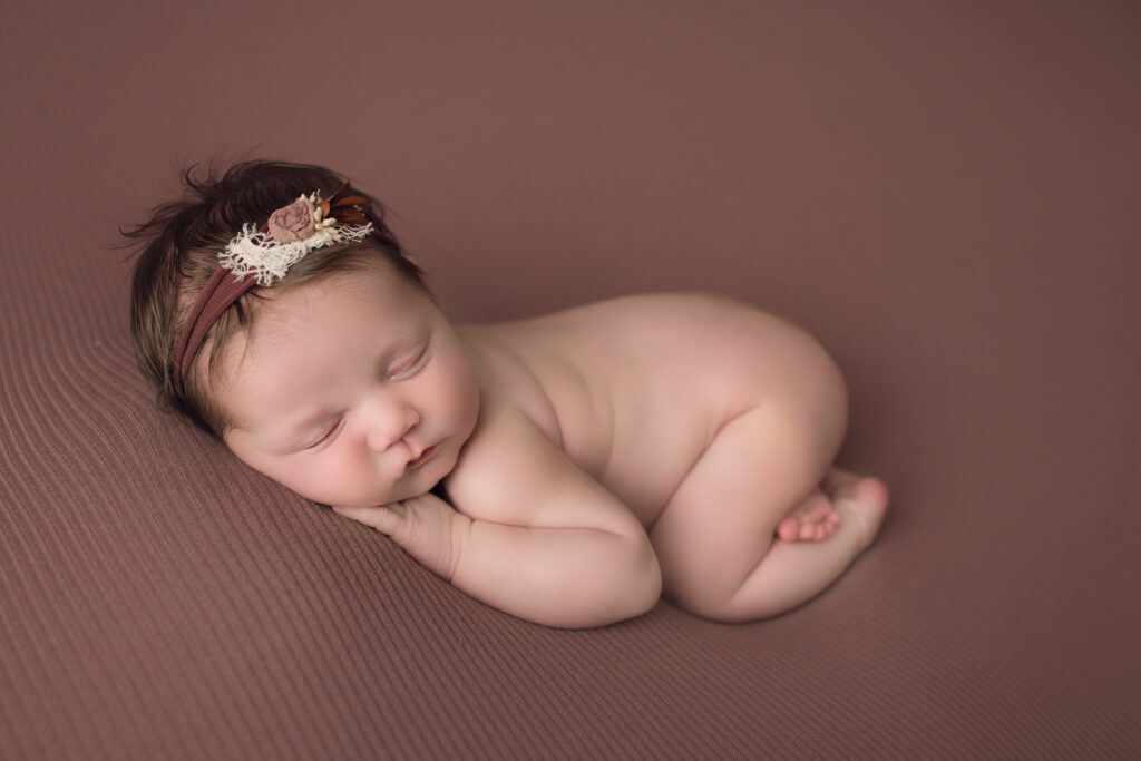 newborn photography cary nc newborn baby girl sleeping with bum up on a pink blanket