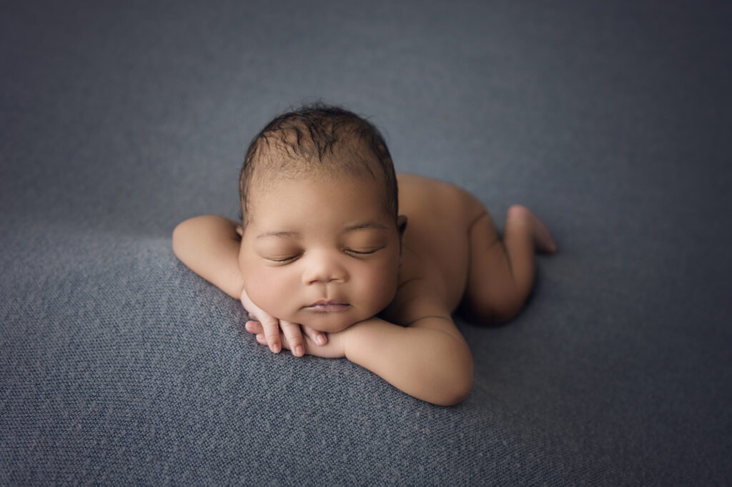### Newborn baby boy face forward on blue blanket