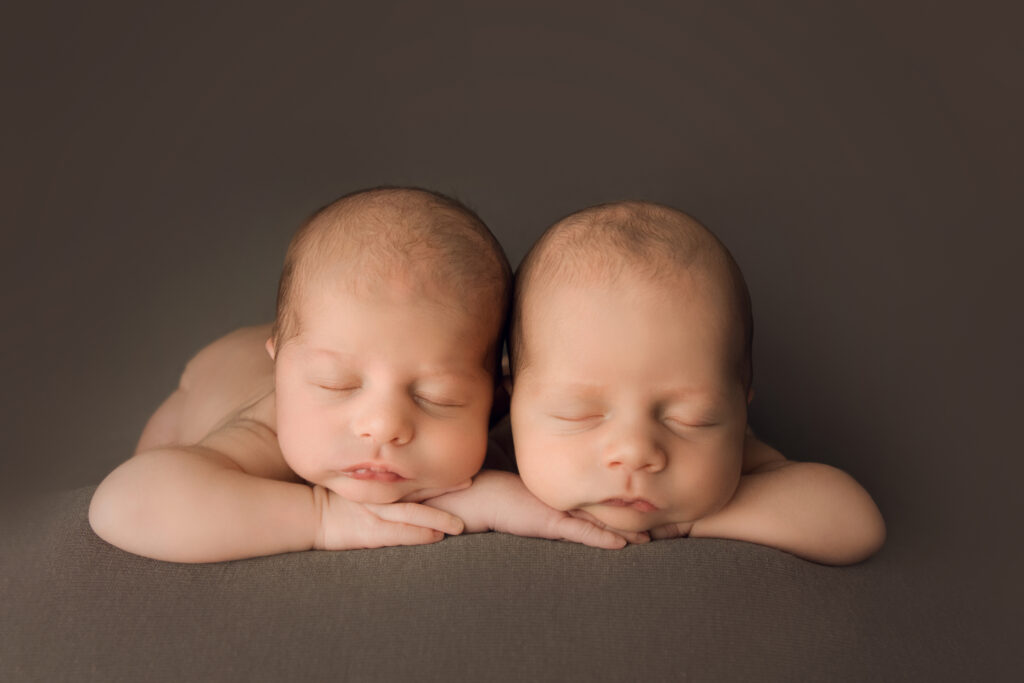 Newborn Baby twin boys laying face forward on a brown blanket Newborn Photography in Raleigh