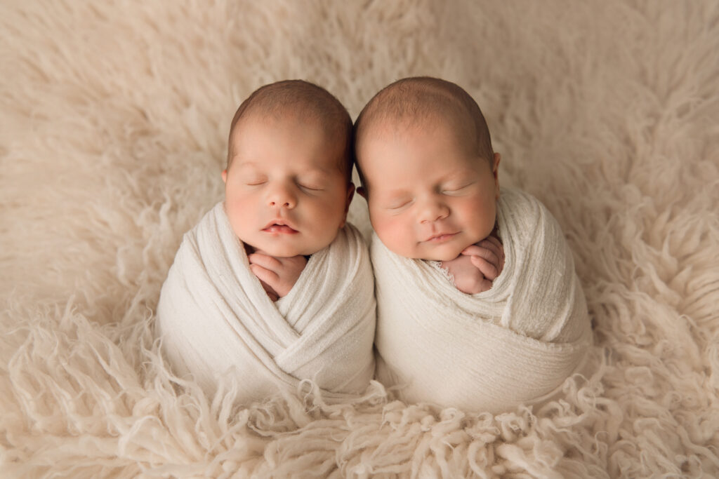 Newborn Baby twin boys wrapped in cream on cream fur Newborn Photography in Raleigh