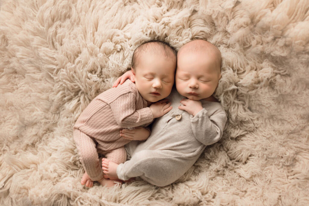 Newborn twins sleeping on plush beige blanket - Sally Salerno Photography